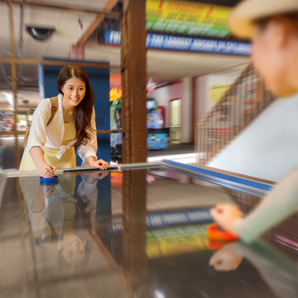 girls playing air hockey at funspot